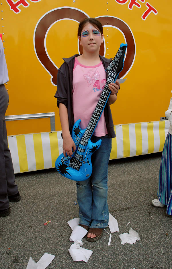 Girl with an inflatable guitar, Wakarusa Maple Syrup Festival