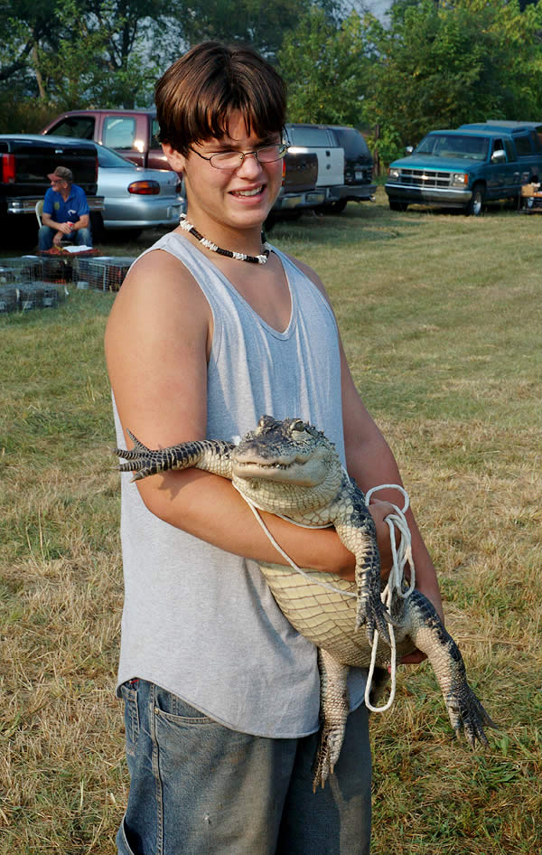 Boy with alligator, Animal Swap Meet, Starke County 