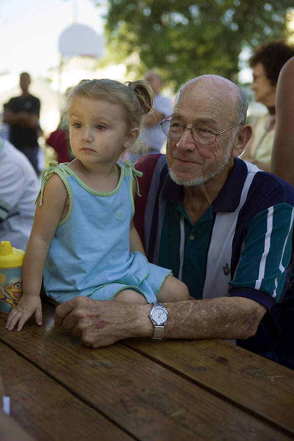 Charles Miller and his great-granddaughter Kiyla, watching the Teen Talent show, Monterey Days