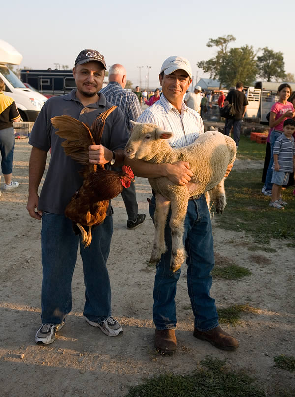 Two friends carrying their animals, Animal Swap Meet, Kankakee, IL