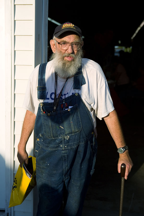 Man at the entrance to the Commercial Building, Starke County Fair, Hamlet